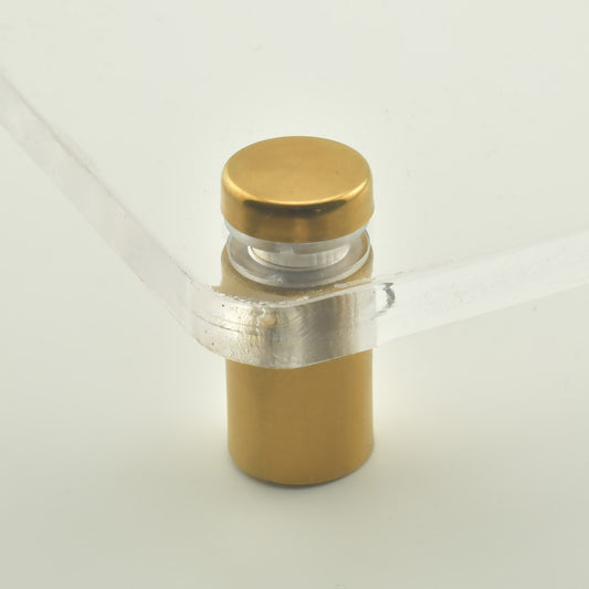 Distantier cilindric din inox auriu asezat vertical langa o saiba aurie, pe fundal deschis.